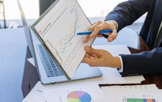 Free Business professionals discussing financial graphs and charts in an office setting. Stock Photo
