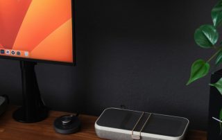 a desk with a laptop, keyboard, mouse and a monitor
