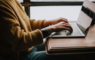 person sitting front of laptop